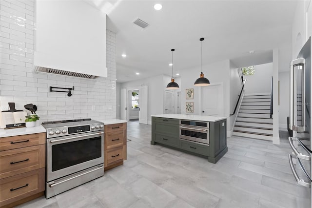 806 W Adalee St, Tampa, FL 33603 - kitchen featuring appliances with stainless steel finishes, tasteful backsplash, light countertops, brown cabinetry, and recessed lighting