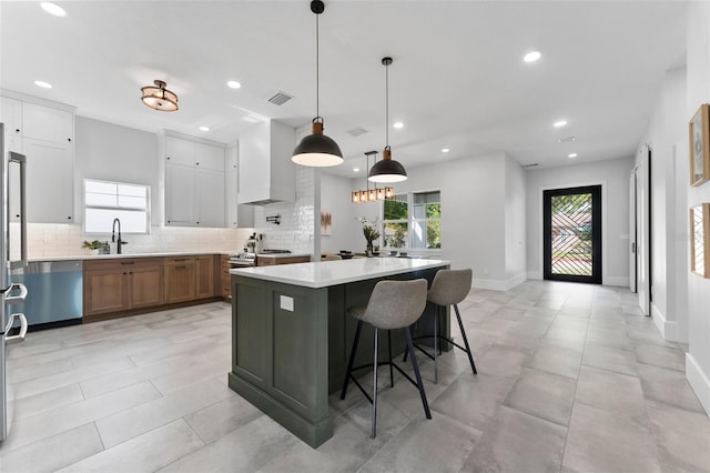 806 W Adalee St, Tampa, FL 33603 - kitchen with wall chimney range hood, stainless steel dishwasher, tasteful backsplash, recessed lighting, and light countertops