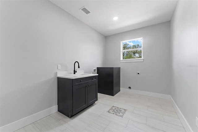 806 W Adalee St, Tampa, FL 33603 - washroom featuring electric dryer hookup, cabinet space, and baseboards