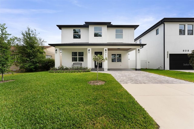 806 W Adalee St, Tampa, FL 33603 - view of front facade featuring driveway, a porch, stucco siding, and a front lawn