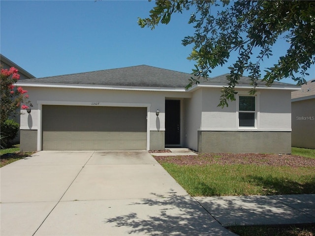 11527 Southern Creek Dr, Gibsonton, FL 33534 - ranch-style house with a garage, stucco siding, and driveway