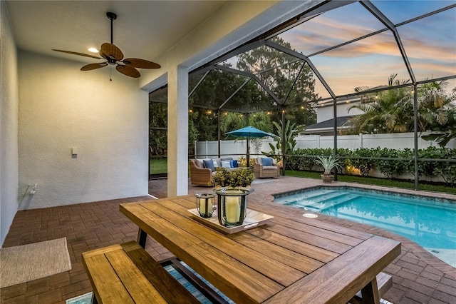 13008 Eagles Entry Dr, Odessa, FL 33556 - pool at dusk with a patio, outdoor lounge area, a lanai, and a ceiling fan