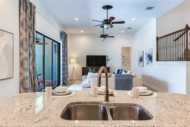 13008 Eagles Entry Dr, Odessa, FL 33556 - kitchen featuring a sink, ceiling fan, light stone countertops, recessed lighting, and open floor plan