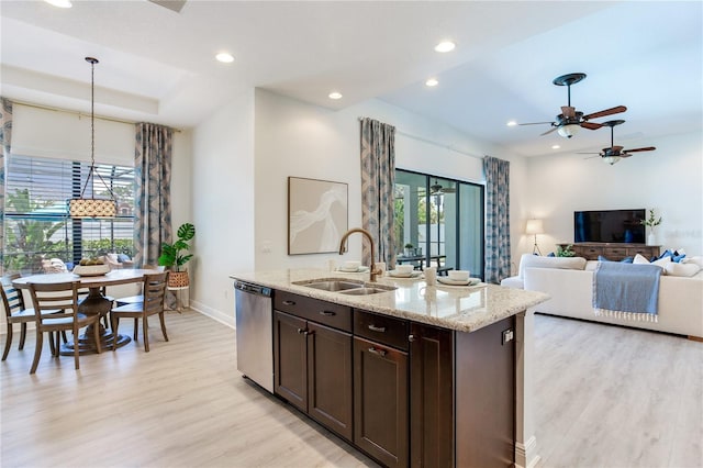 13008 Eagles Entry Dr, Odessa, FL 33556 - kitchen featuring stainless steel dishwasher, a sink, light wood finished floors, baseboards, and dark brown cabinets