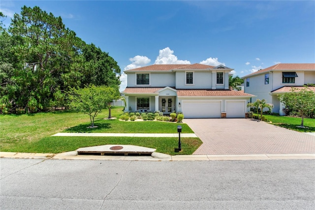 13008 Eagles Entry Dr, Odessa, FL 33556 - view of front facade featuring an attached garage, decorative driveway, a front lawn, and stucco siding