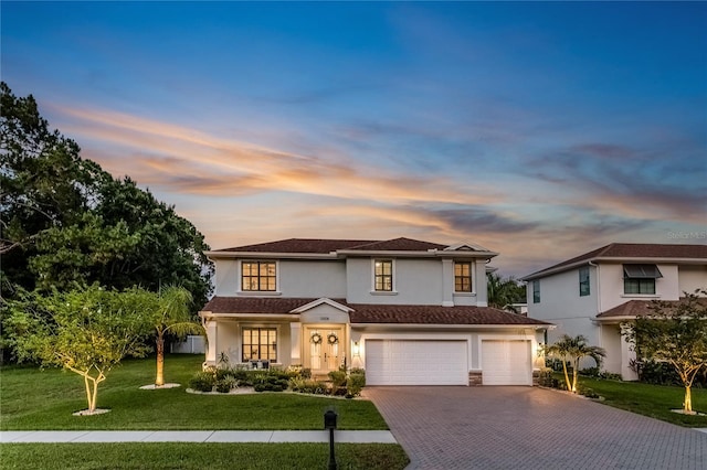 13008 Eagles Entry Dr, Odessa, FL 33556 - view of front facade featuring stucco siding, driveway, a yard, and an attached garage