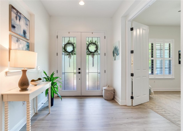 13008 Eagles Entry Dr, Odessa, FL 33556 - foyer with french doors, wood finished floors, baseboards, and recessed lighting