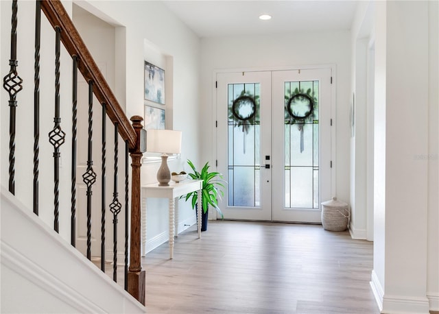 13008 Eagles Entry Dr, Odessa, FL 33556 - entryway with french doors, healthy amount of natural light, wood finished floors, baseboards, and recessed lighting