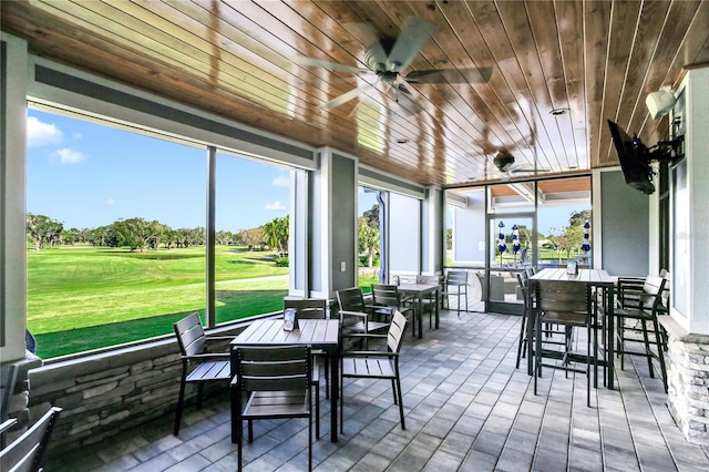 13008 Eagles Entry Dr, Odessa, FL 33556 - sunroom with view of golf course, outdoor dining area, ceiling fan, and plenty of natural light