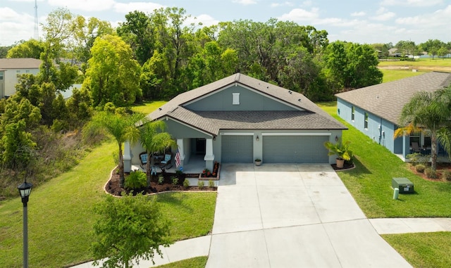 6416 Cobble Bliss St, Zephyrhills, FL 33541 - view of front of home with a garage, stucco siding, a front lawn, driveway, and a shingled roof
