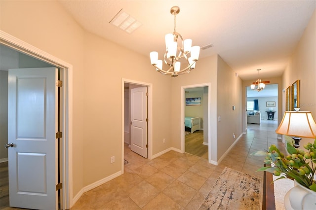 6416 Cobble Bliss St, Zephyrhills, FL 33541 - hall with baseboards, visible vents, light tile patterned floors, and a chandelier