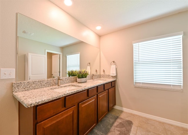 6416 Cobble Bliss St, Zephyrhills, FL 33541 - full bath featuring baseboards, double vanity, a sink, and a healthy amount of sunlight
