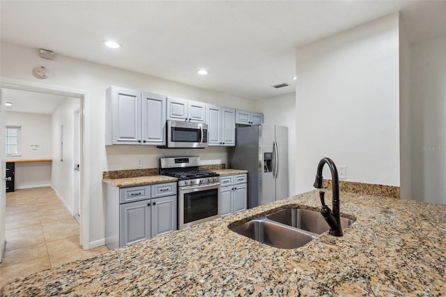 1308 W Perdiz St, Tampa, FL 33612 - kitchen with a sink, light tile patterned floors, stainless steel appliances, light stone countertops, and recessed lighting