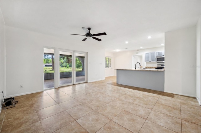 1308 W Perdiz St, Tampa, FL 33612 - unfurnished living room featuring a ceiling fan, a sink, light tile patterned floors, baseboards, and recessed lighting