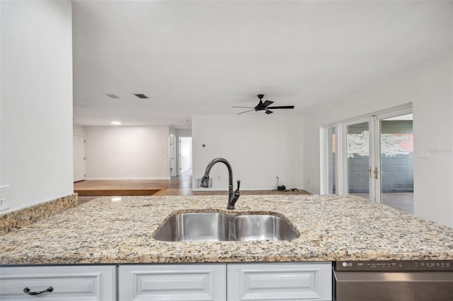 1308 W Perdiz St, Tampa, FL 33612 - kitchen with a ceiling fan, stainless steel dishwasher, a sink, light stone countertops, and white cabinetry