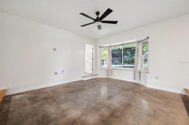 1308 W Perdiz St, Tampa, FL 33612 - empty room featuring a ceiling fan, baseboards, and concrete floors