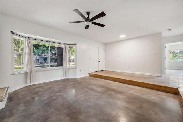 1308 W Perdiz St, Tampa, FL 33612 - unfurnished living room with a ceiling fan, finished concrete flooring, baseboards, visible vents, and recessed lighting