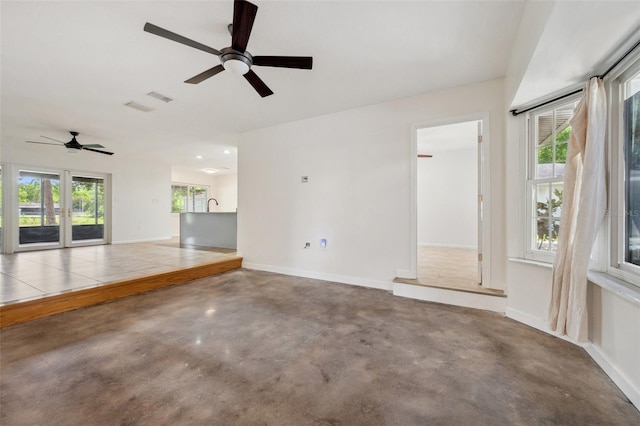 1308 W Perdiz St, Tampa, FL 33612 - unfurnished living room featuring baseboards, visible vents, finished concrete floors, and ceiling fan