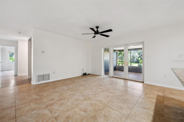 1308 W Perdiz St, Tampa, FL 33612 - empty room featuring ceiling fan, a wealth of natural light, light tile patterned flooring, and visible vents