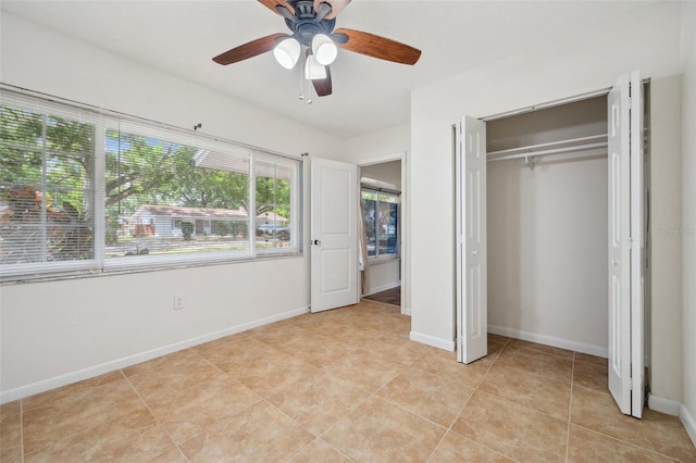1308 W Perdiz St, Tampa, FL 33612 - unfurnished bedroom with a ceiling fan, baseboards, a closet, and light tile patterned floors