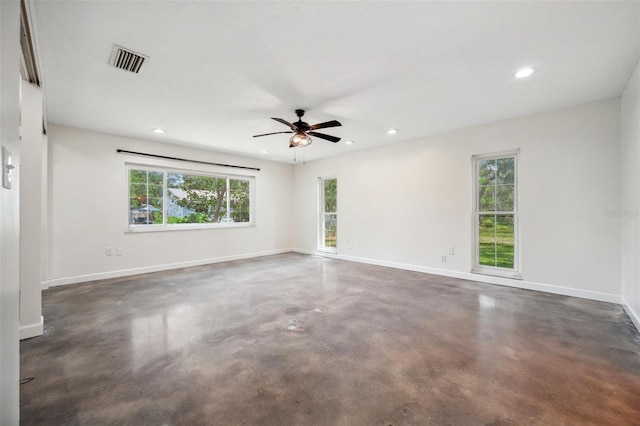 1308 W Perdiz St, Tampa, FL 33612 - empty room with ceiling fan, a wealth of natural light, visible vents, and finished concrete flooring
