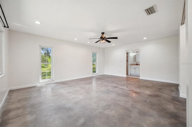 1308 W Perdiz St, Tampa, FL 33612 - empty room featuring ceiling fan, a wealth of natural light, visible vents, and finished concrete flooring