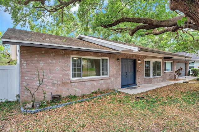 1308 W Perdiz St, Tampa, FL 33612 - single story home with brick siding, fence, and a garage