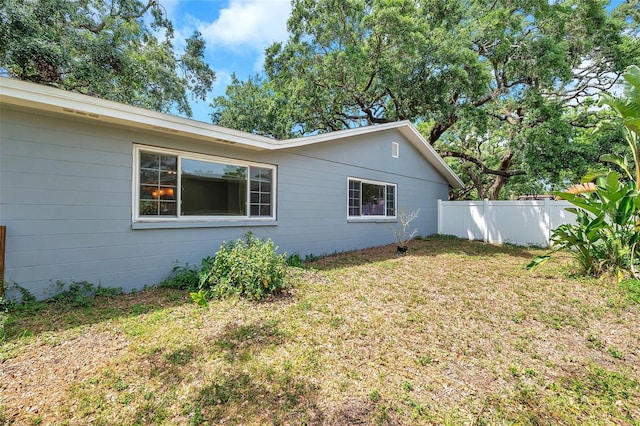 1308 W Perdiz St, Tampa, FL 33612 - view of side of property with a lawn and fence