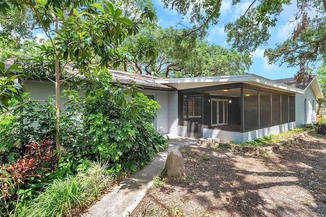 1308 W Perdiz St, Tampa, FL 33612 - rear view of house featuring a sunroom and concrete block siding