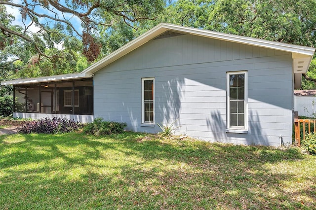 1308 W Perdiz St, Tampa, FL 33612 - view of property exterior with a lawn and a sunroom