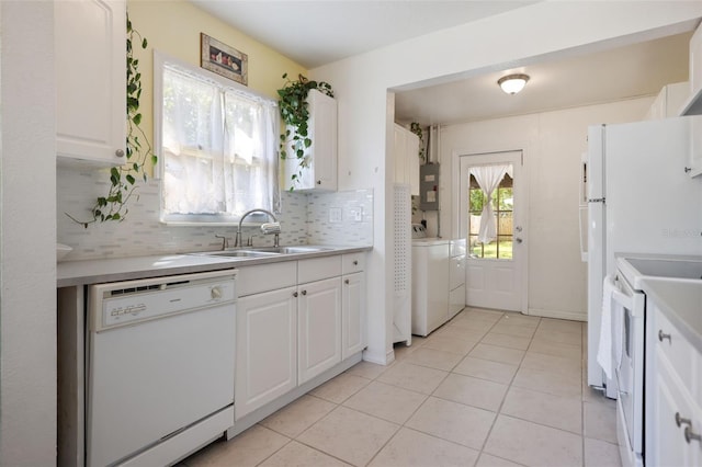 kitchen with light countertops, white cabinets, a sink, and white appliances