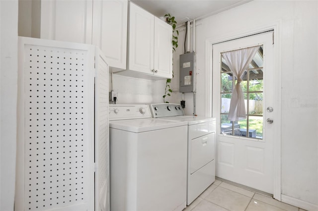 clothes washing area with electric panel, washing machine and clothes dryer, cabinet space, and light tile patterned floors