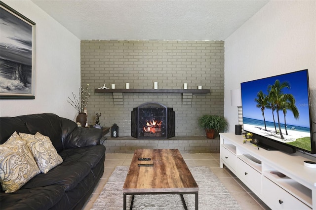 living room featuring a brick fireplace, a textured ceiling, and light tile patterned floors