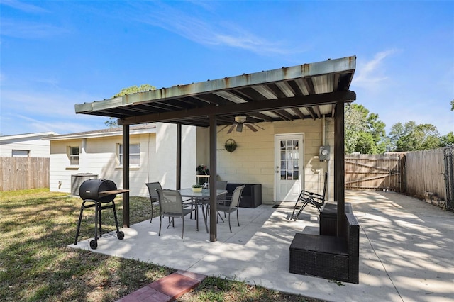 view of patio / terrace featuring a ceiling fan, a fenced backyard, area for grilling, and outdoor dining space