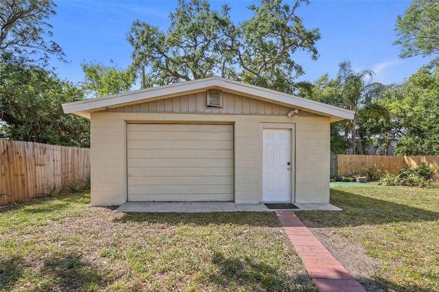 detached garage featuring fence
