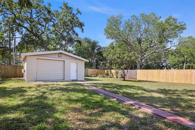view of yard featuring a fenced backyard, a shed, and an outdoor structure