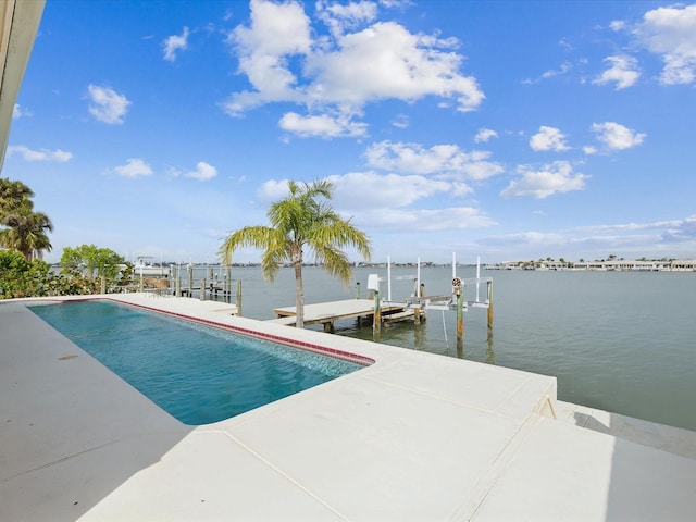 view of swimming pool featuring a water view, boat lift, and a dock