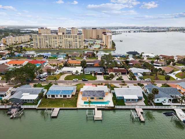 birds eye view of property featuring a water view and a city view