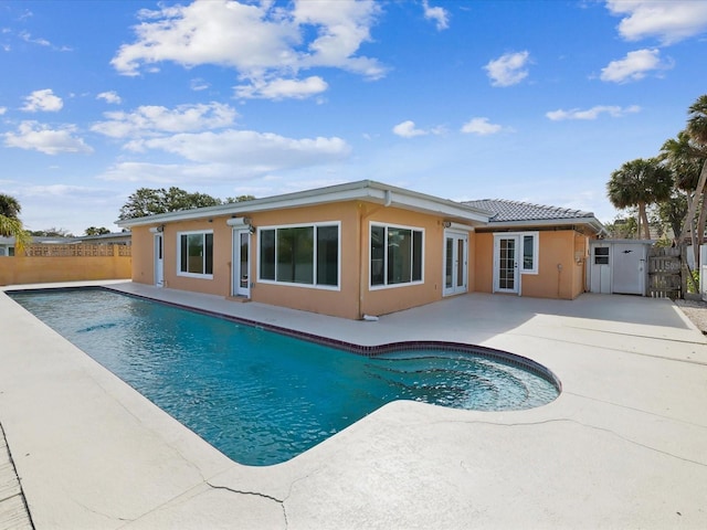 view of pool with french doors, fence, a fenced in pool, and a patio