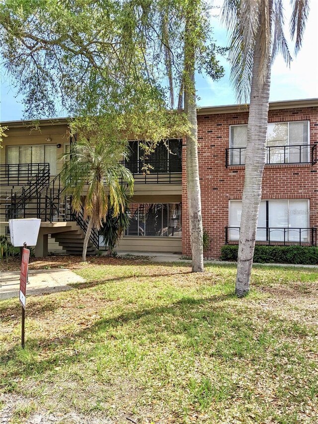 1257 Drew St Unit 8, Clearwater, FL 33755 - back of property with stairway and a yard