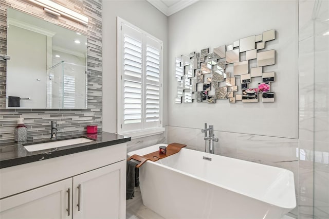 bathroom with ornamental molding, tile walls, plenty of natural light, and a soaking tub
