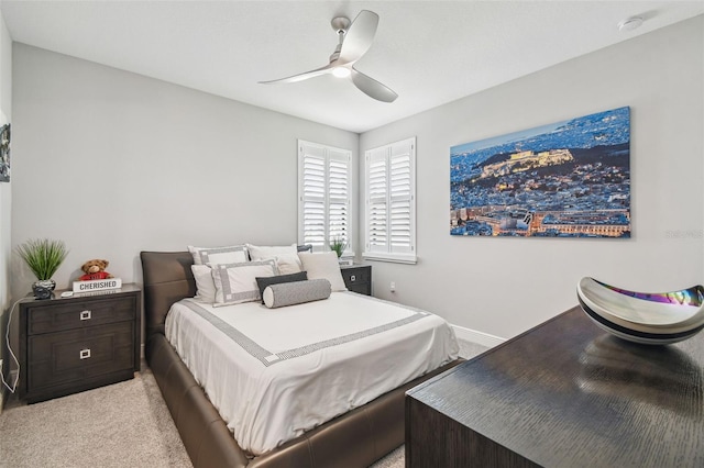 bedroom featuring light carpet, baseboards, and ceiling fan