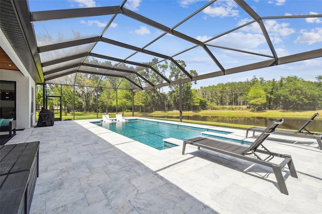 pool with a water view, a patio, and glass enclosure