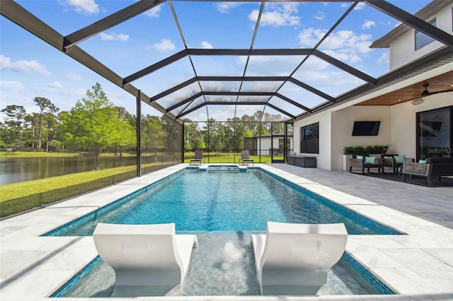 view of pool featuring a water view, outdoor lounge area, a pool with connected hot tub, a ceiling fan, and a patio