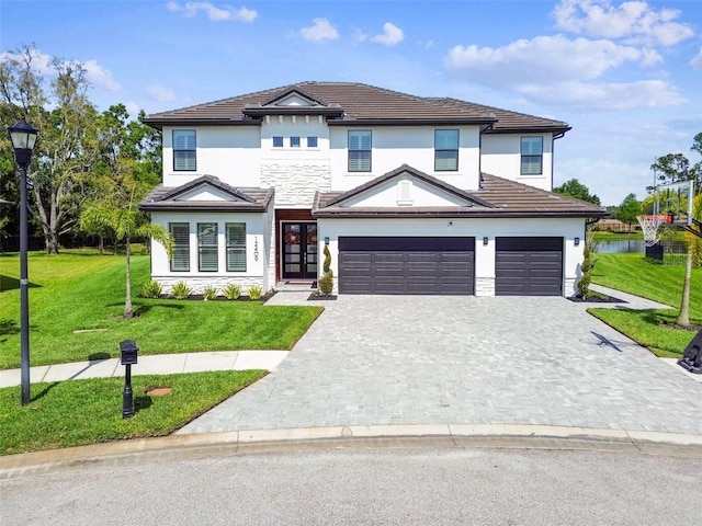 view of front facade featuring stucco siding, a front lawn, and decorative driveway