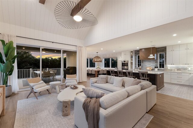 311 Spring Ave, Anna Maria, FL 34216 - living area featuring light wood-type flooring, high vaulted ceiling, and recessed lighting