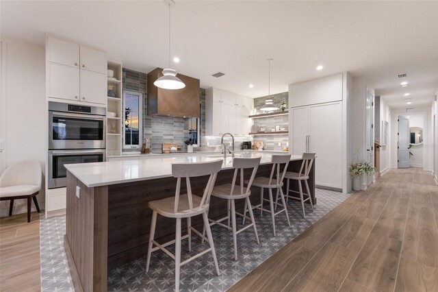 311 Spring Ave, Anna Maria, FL 34216 - kitchen with open shelves, double oven, and tasteful backsplash