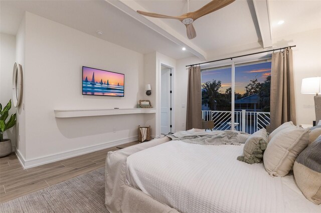 311 Spring Ave, Anna Maria, FL 34216 - bedroom with baseboards, beam ceiling, access to exterior, ceiling fan, and wood finished floors