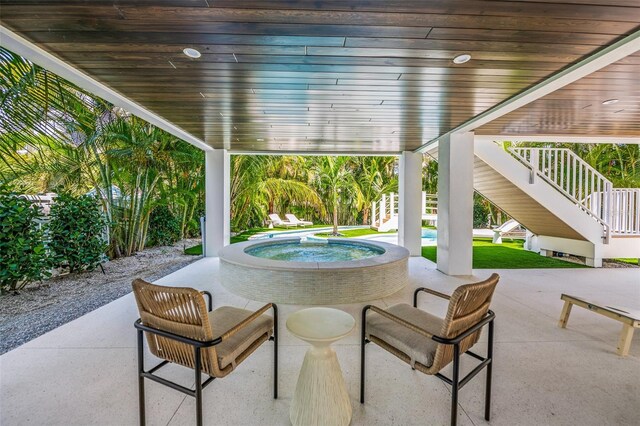 311 Spring Ave, Anna Maria, FL 34216 - view of patio featuring an outdoor pool, an in ground hot tub, and stairs