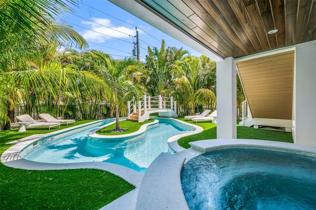 311 Spring Ave, Anna Maria, FL 34216 - pool featuring a hot tub and a lawn